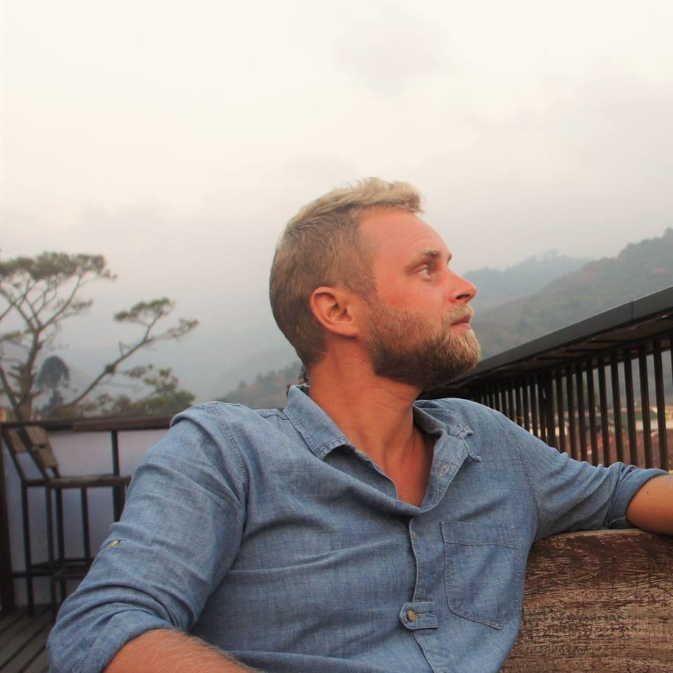 Portrait of Erik Nylund with mountains in the background.