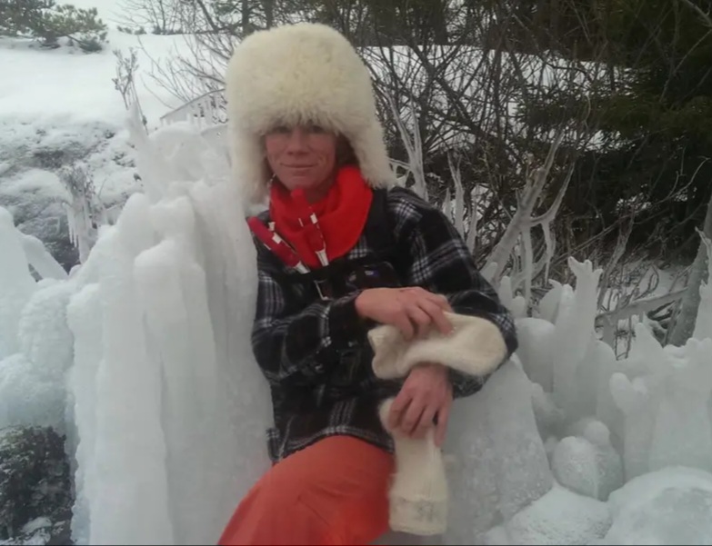 Portrait of Toya Westerberg with snow and trees in the background.